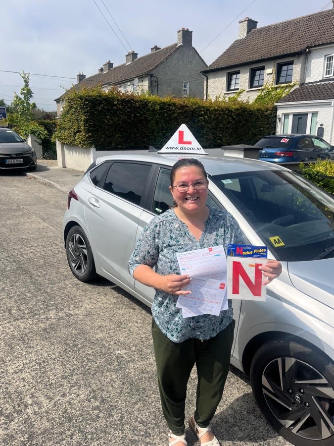 Learner driver celebrating a driving test pass with Dundrum School of Motoring